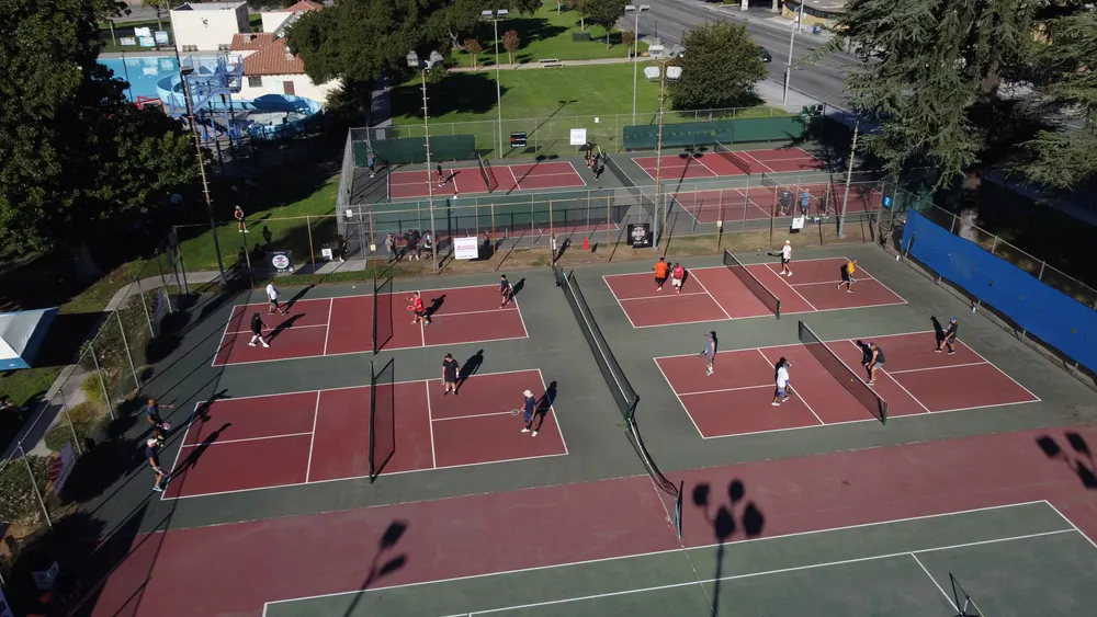 Overhead drone view of tournament matches in progress on the Perris Hill courts