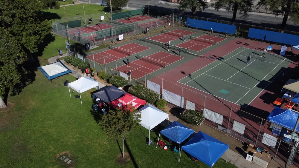 Drone view of the tournament courts and tents from above the park