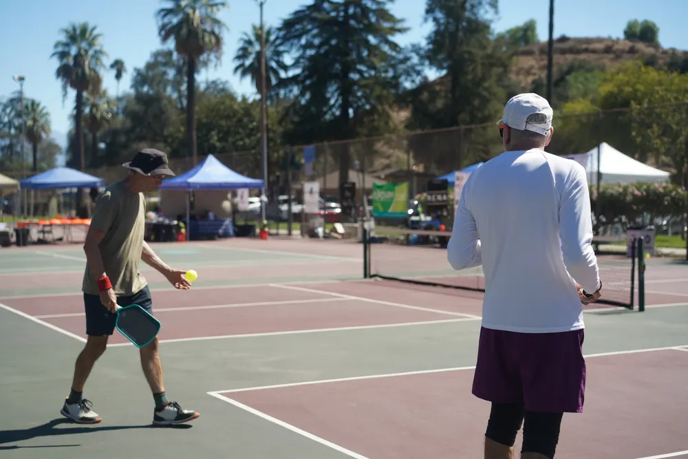 Player preparing to serve during a doubles match